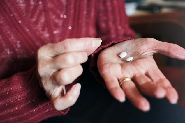Senior woman's hands counting out pills