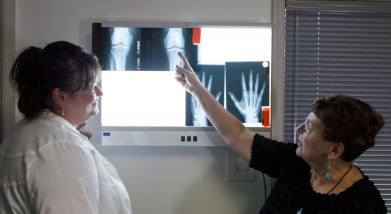 Patient and doctor reviewing x-rays