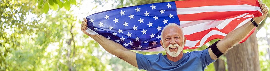 Veteran holding an American flag above his head
