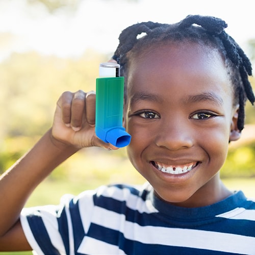 Young child with blue gradient asthma inhaler