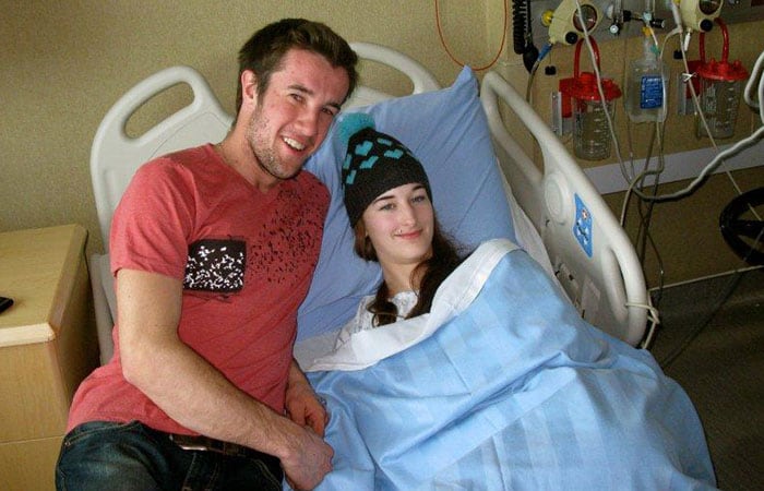 Suzanne Lambregts in a hospital bed with her boyfriend.