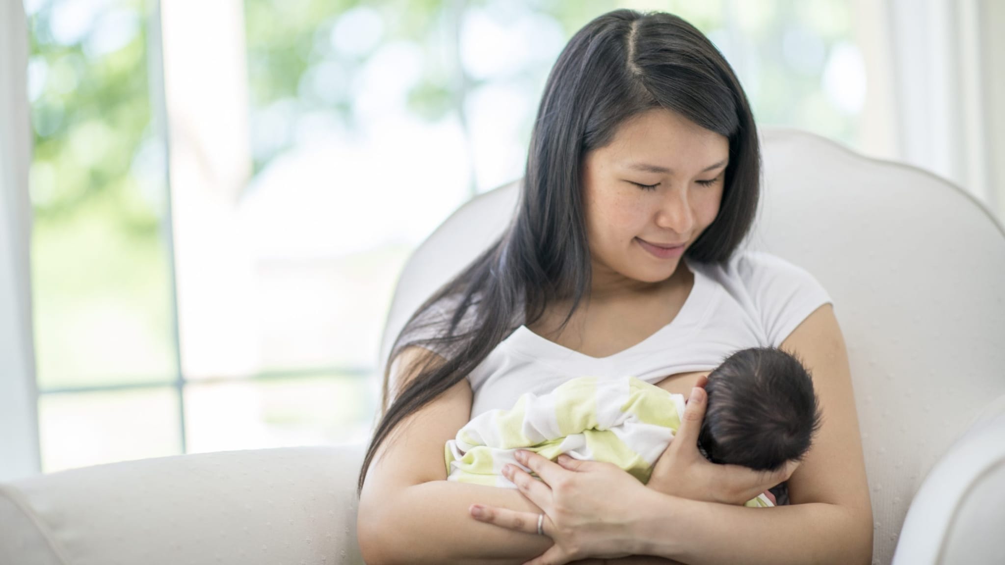Woman breastfeeding an infant.