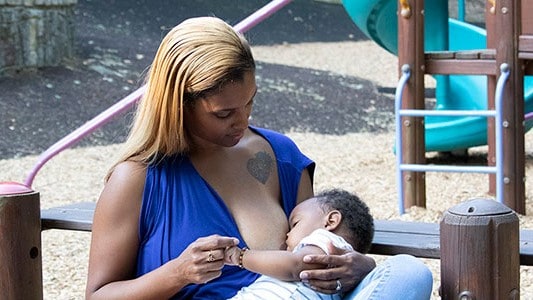 A mother breastfeeding her child.