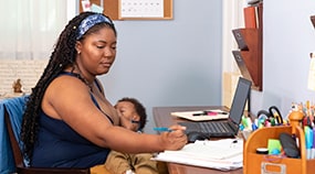 Breastfeeding mother on a home office