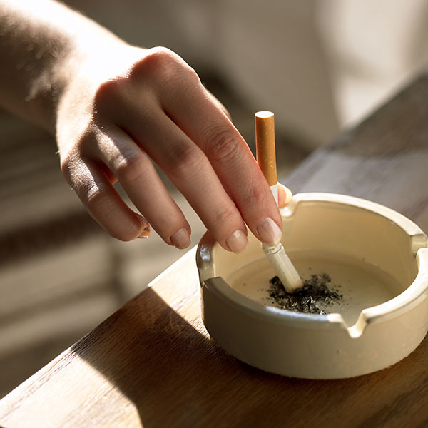 Photo: Putting a cigarette out in an ashtray.