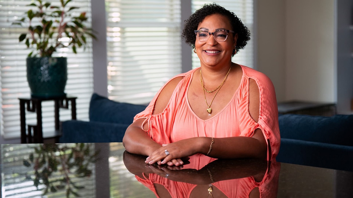 Carletta sitting at a table and smiling