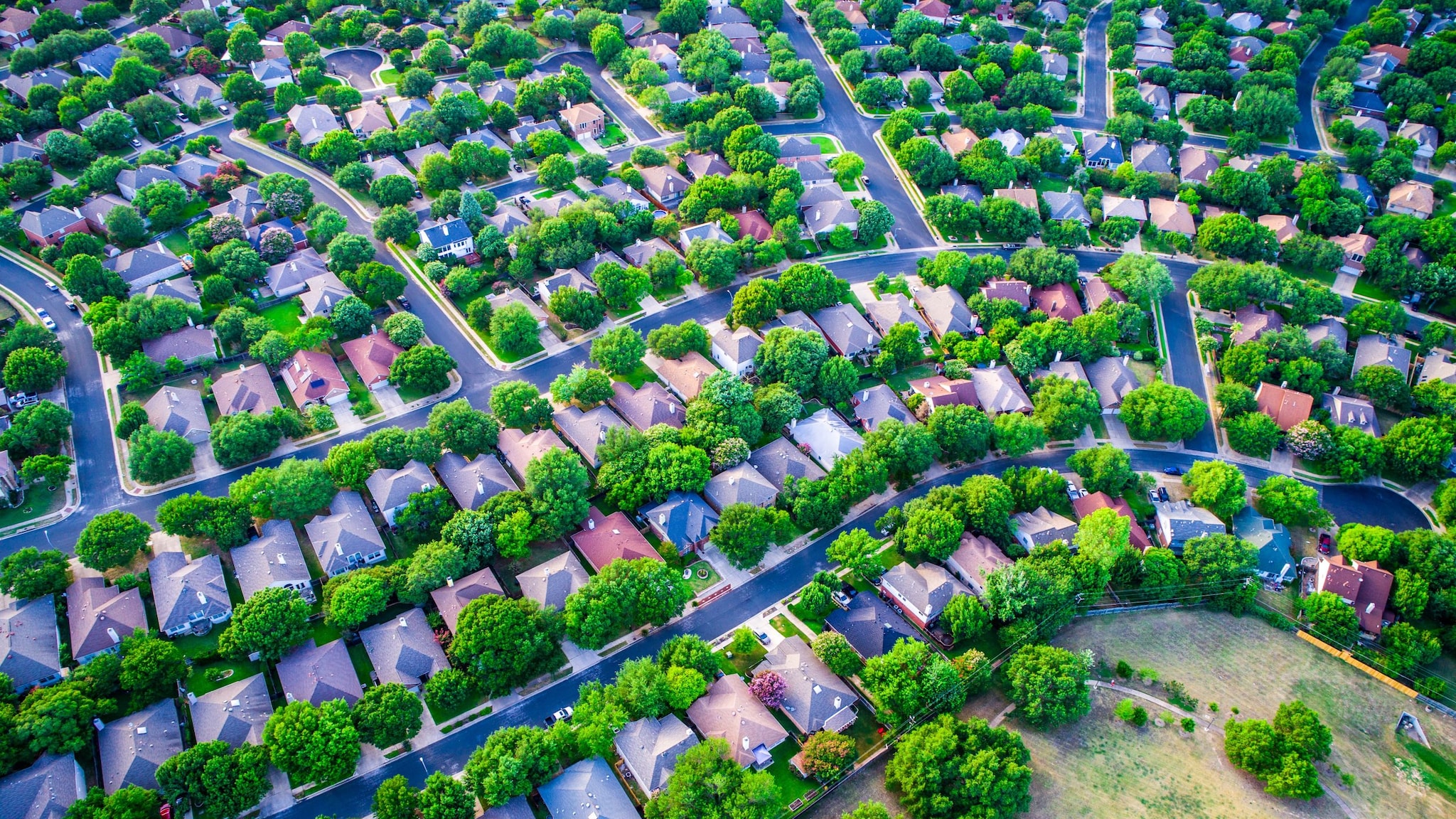 Aerial view of a neighborhood with many houses and trees.