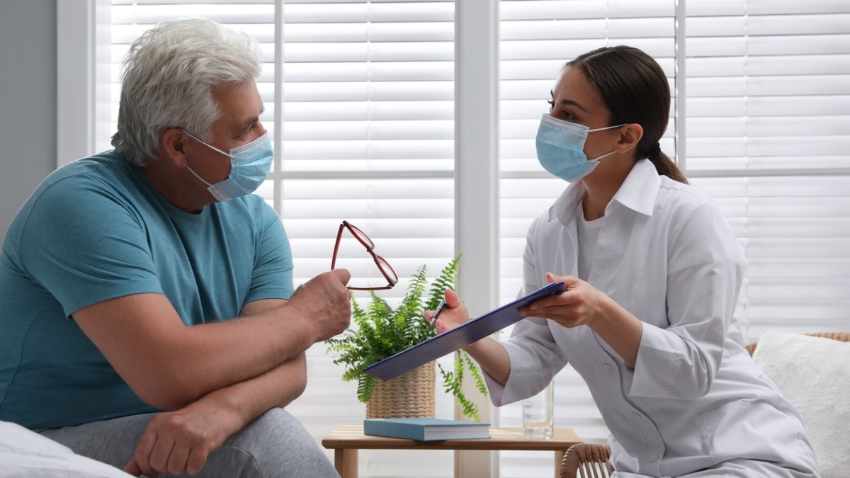 Photo of a nurse discussing a survivorship care plan with a patient