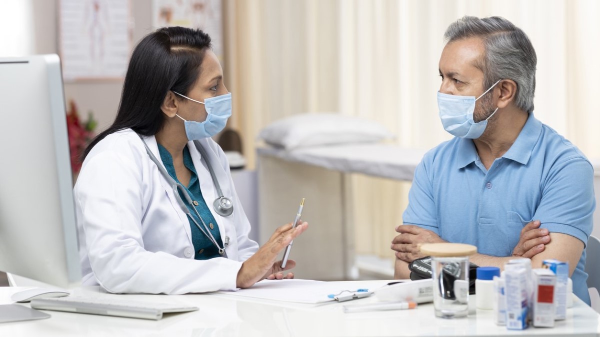 Photo of a doctor explaining treatment to a patient