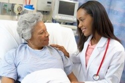 Photo of a woman in a hospital talking to her doctor