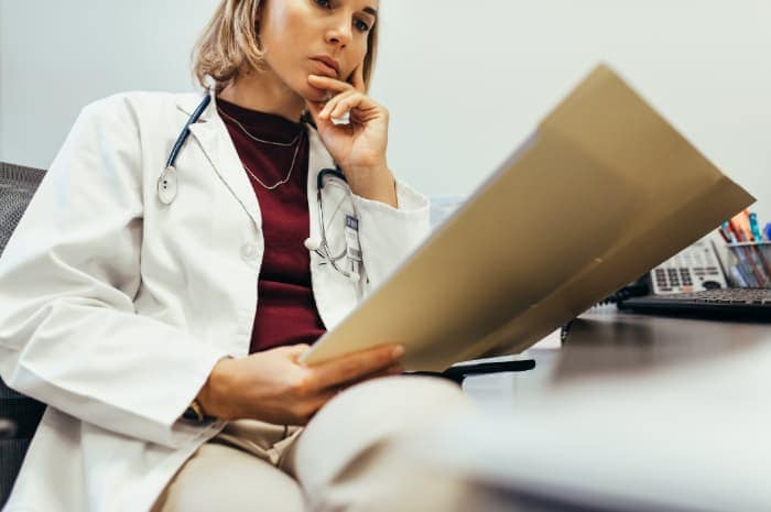 Photo of a doctor reading a report