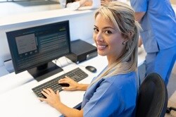 Photo of a clinic staff member reviewing patient medical records