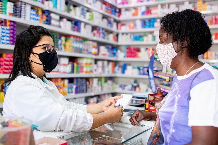Photo of a pharmacist talking to a patient about her prescription