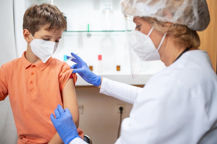 Photo of a doctor giving an HPV shot to a boy