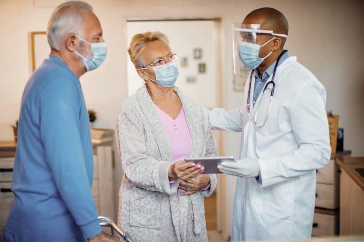 Photo of a man and a woman talking to their doctor