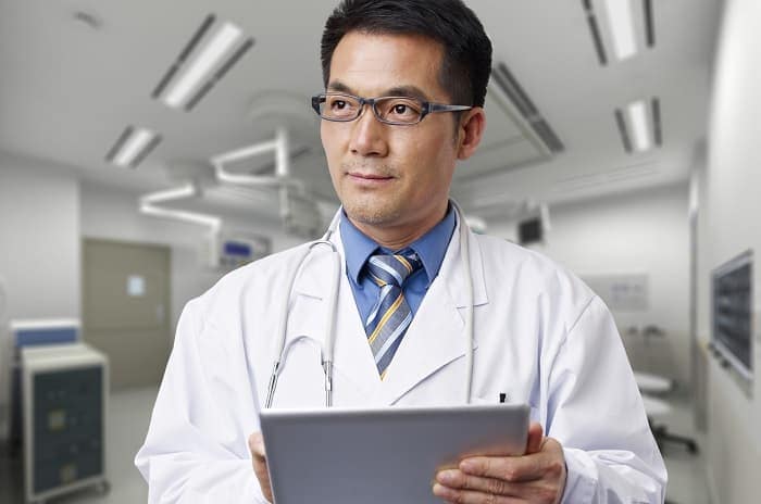 Photo of a doctor holding a digital tablet