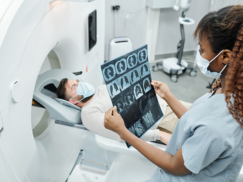 Photo of a doctor helping a patient get screened for lung cancer