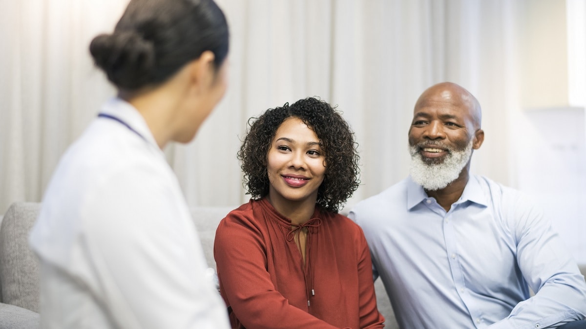 A doctor talking to a man and a woman