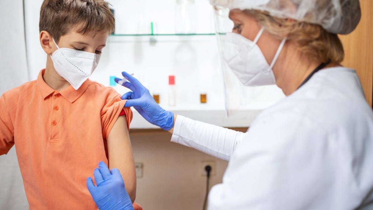 A doctor gives an HPV vaccine to a boy
