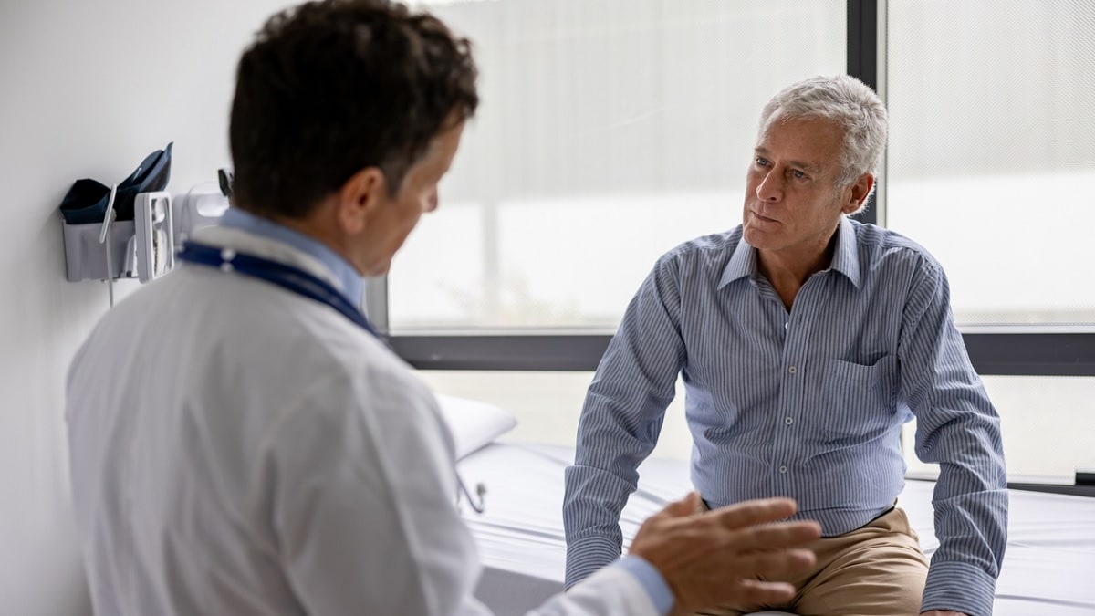 A doctor talking to a male patient