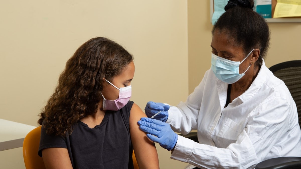 Photo of a doctor giving an HPV vaccine to a girl