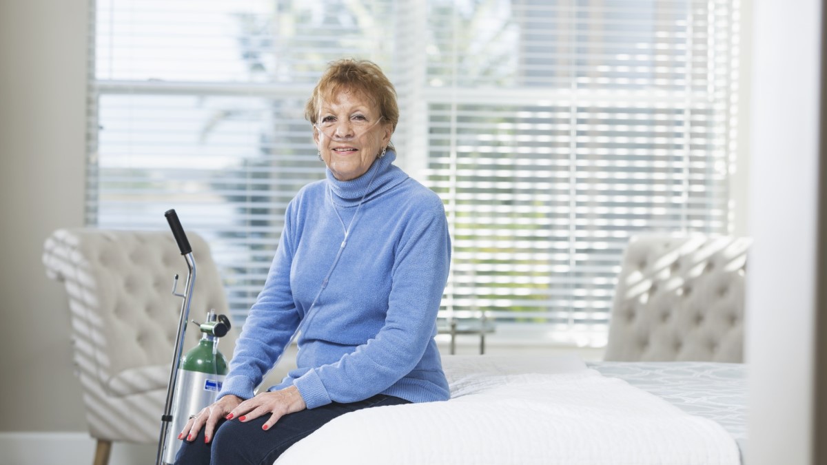 a woman with a portable oxygen tank