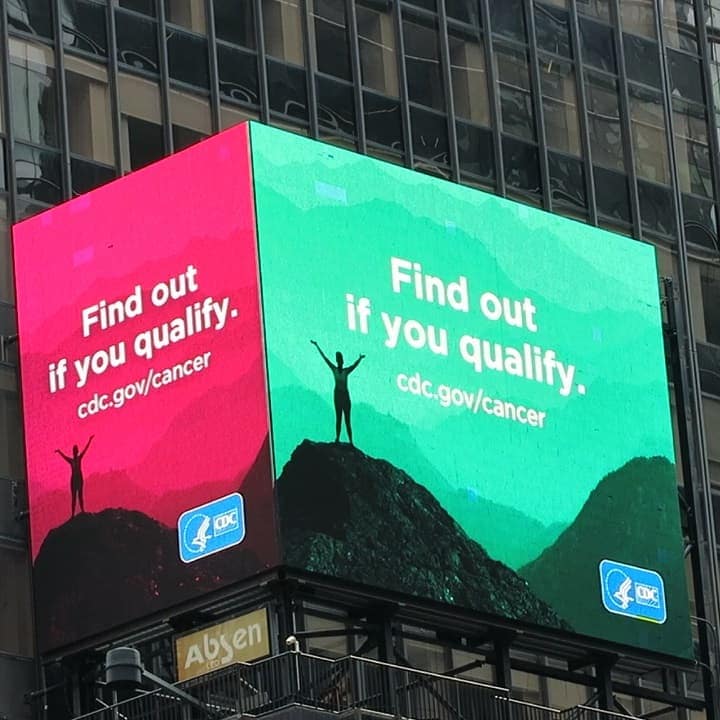 Billboard on Times Square in New York City that says Find out if you qualify. cdc.gov/cancer