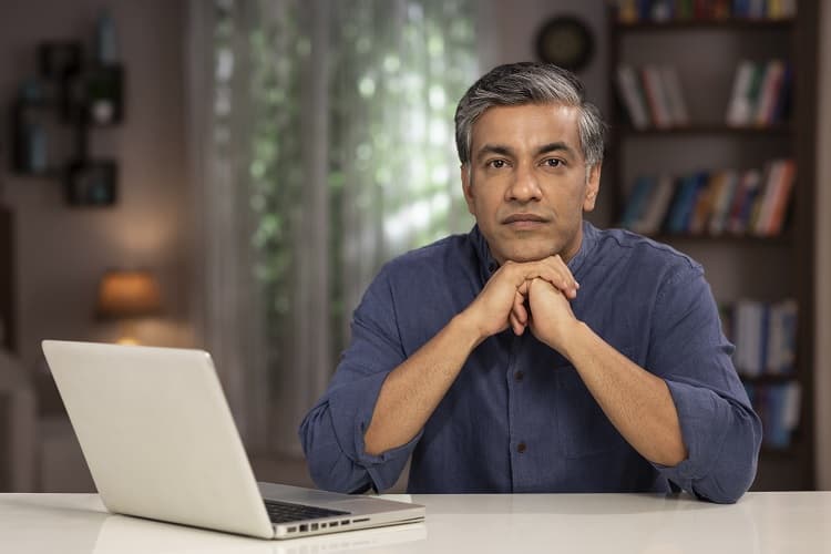 Photo of a man using a laptop computer