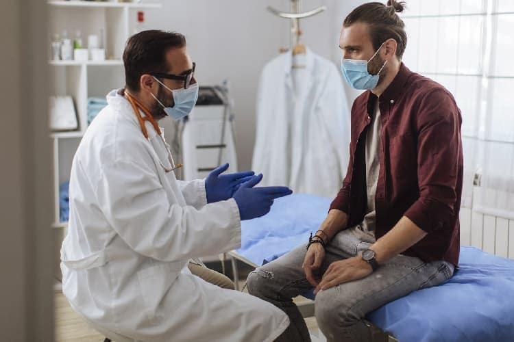 Photo of a doctor talking to a patient.