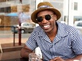 Photo of an African-American man wearing a hat and sunglasses