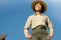 Photo of a park official wearing a hat and a long sleeved shirt.