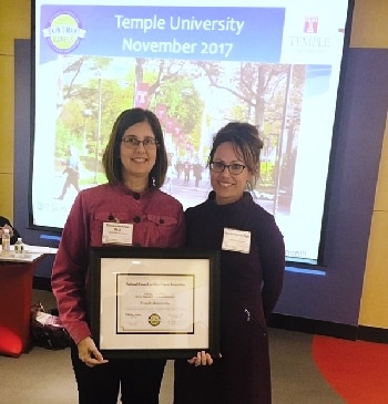 Photo of Dr. Sherry Pagoto presenting Dr. Carolyn Heckman with the Skin Smart Campus award for Temple University.