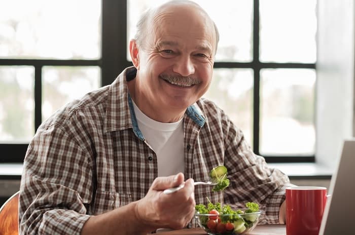 Photo of a man eating a salad