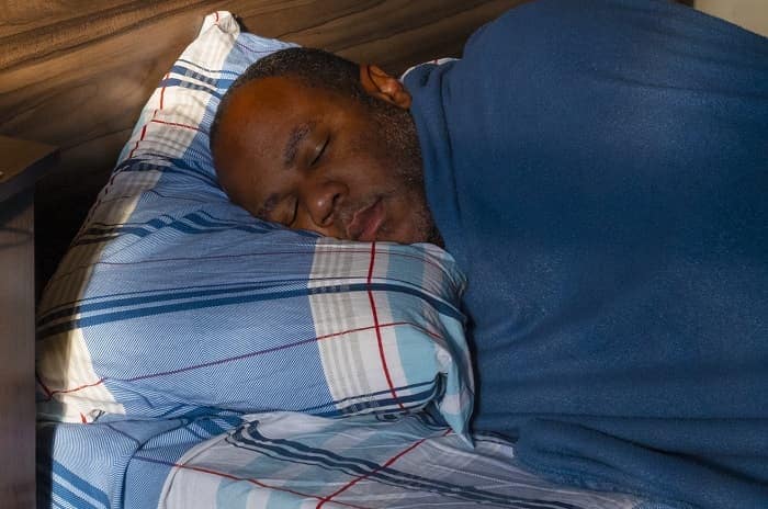 Photo of a man sleeping in bed
