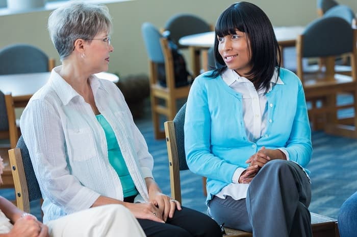 Photo of two women talking in a support group
