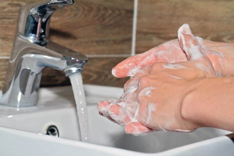 Photo of a person washing his hands