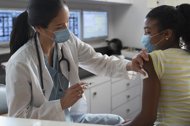 Photo of a doctor giving an HPV vaccine to a girl
