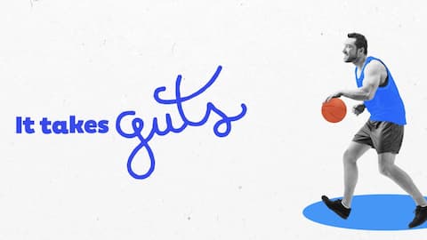 Man dribbling a basketball next to the phrase "It takes guts"