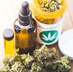 Medical marijuana including marijuana buds, a medicine bottle, and tincture bottle