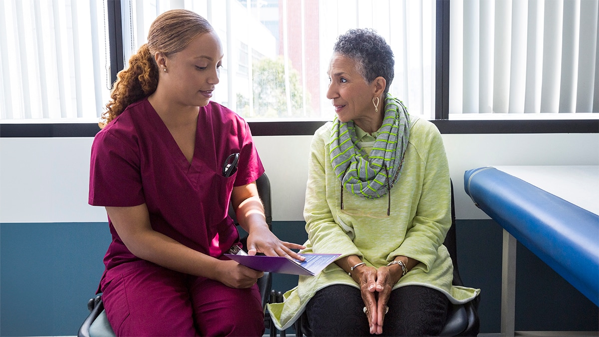 Nurse practitioner talking to an older patient.