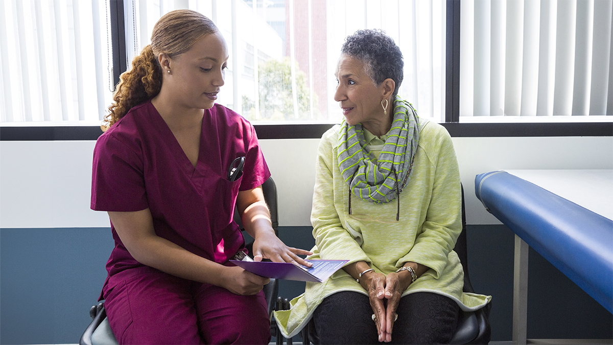 Nurse practitioner talking to an older patient.