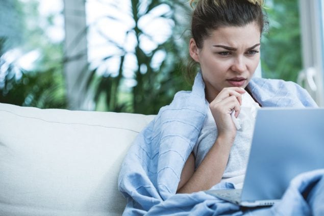 Image of sick woman looking at computer