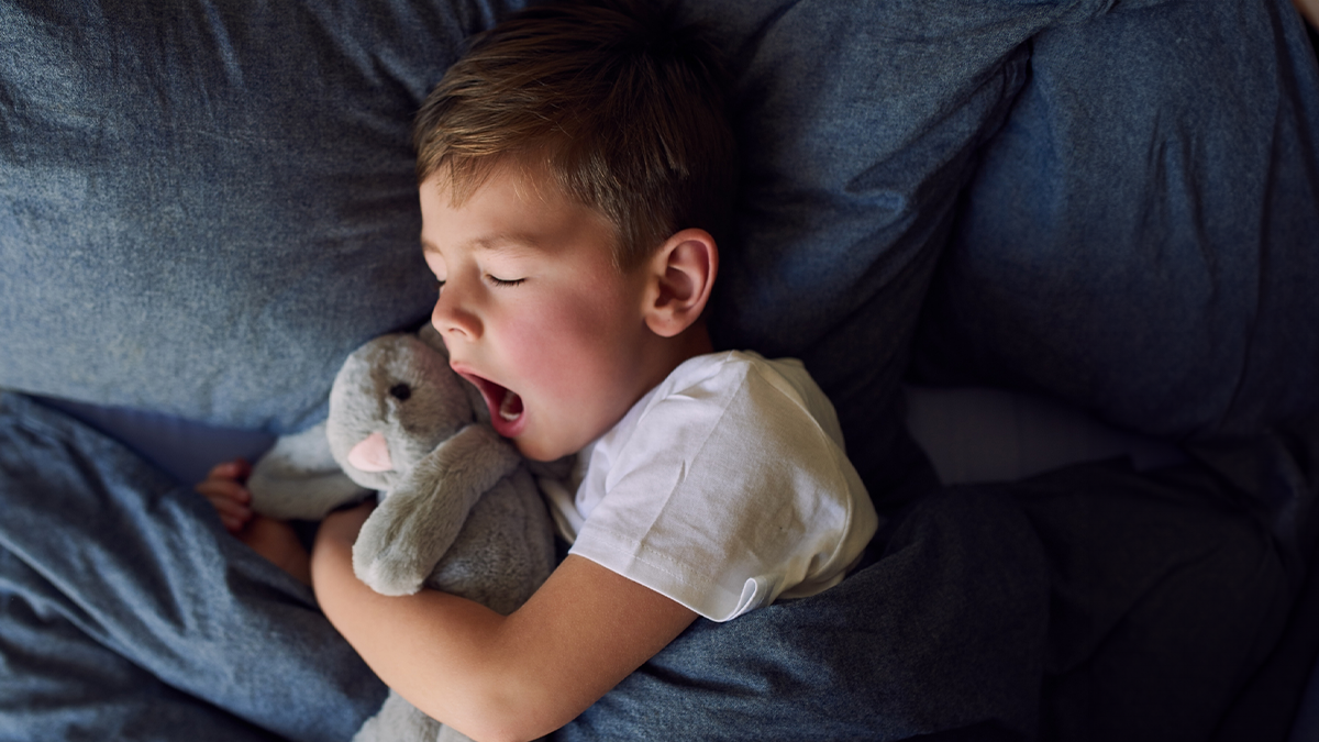 kid sleeping with stuffed bunny