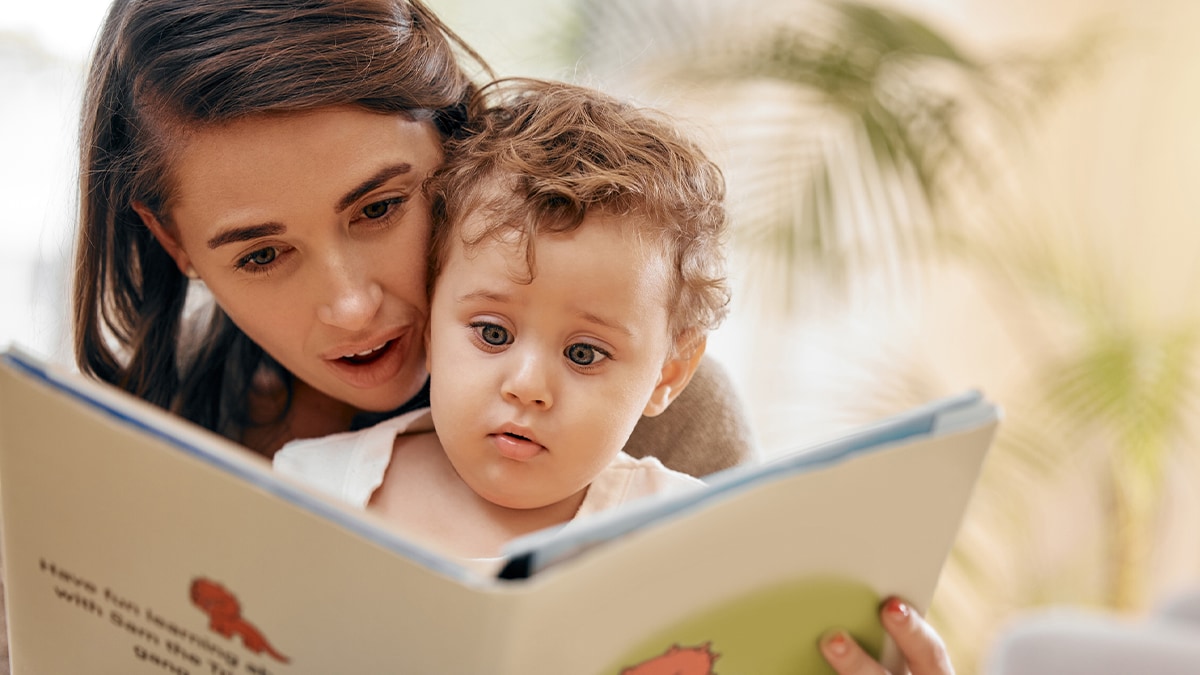 mother reading book with her baby
