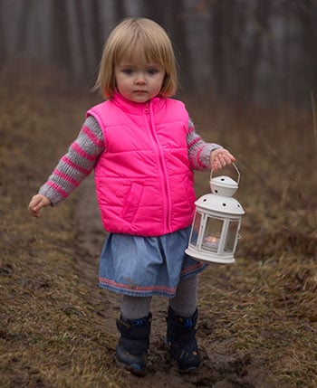 Young girl carrying lantern