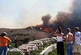 Photo of people looking at a wildfire.