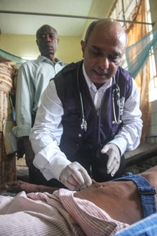 A physician checking a patient for dehydration