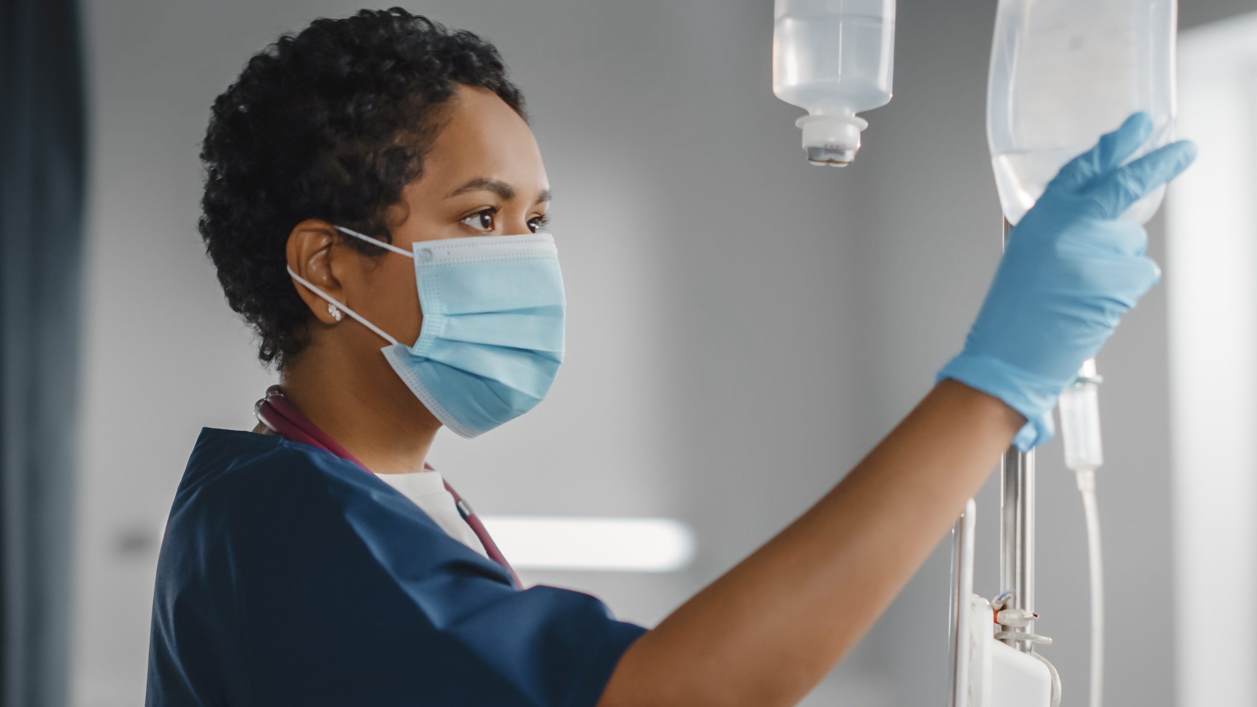 Healthcare provider checks an IV drip