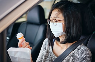 Woman Wearing Mask at Drive-Through Pharmacy