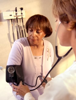 medical professional checking patient's blood pressure